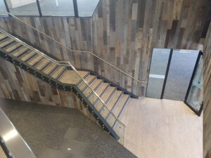 Commercial vinyl tile to stair well installation.